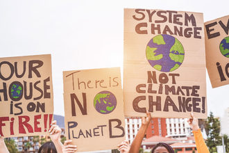 Protestors with earth friendly signs