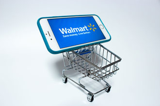Walmart logo on a smartphone in a shopping cart